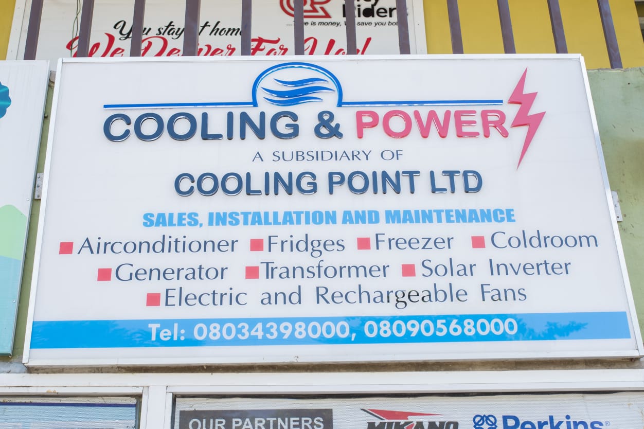 Cooling and Power shopfront sign listing air conditioners, fridges, freezers, cold rooms, generators, transformers and solar inverters
